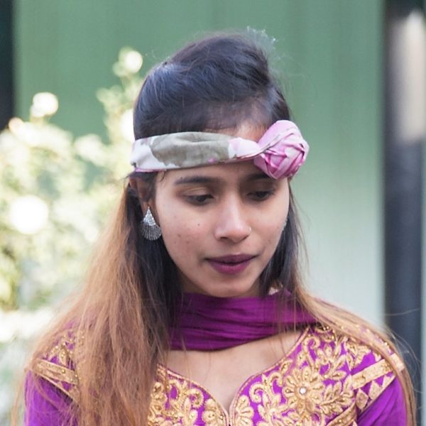 Sristi wearing purple forehead jewelry