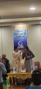 Sristi KC kissing on the hand of the chief guest Anuradha Koirala