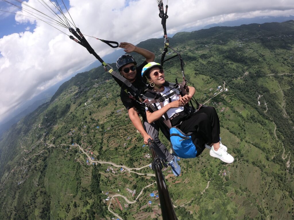 The picture shows Sristi KC experiencing paragliding in the hearts of mountain in pokhara, Nepal
